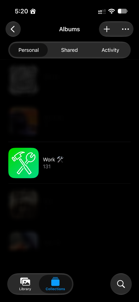 A smartphone screen showing the Work album with a green icon depicting crossed tools in the iOS Photos app.