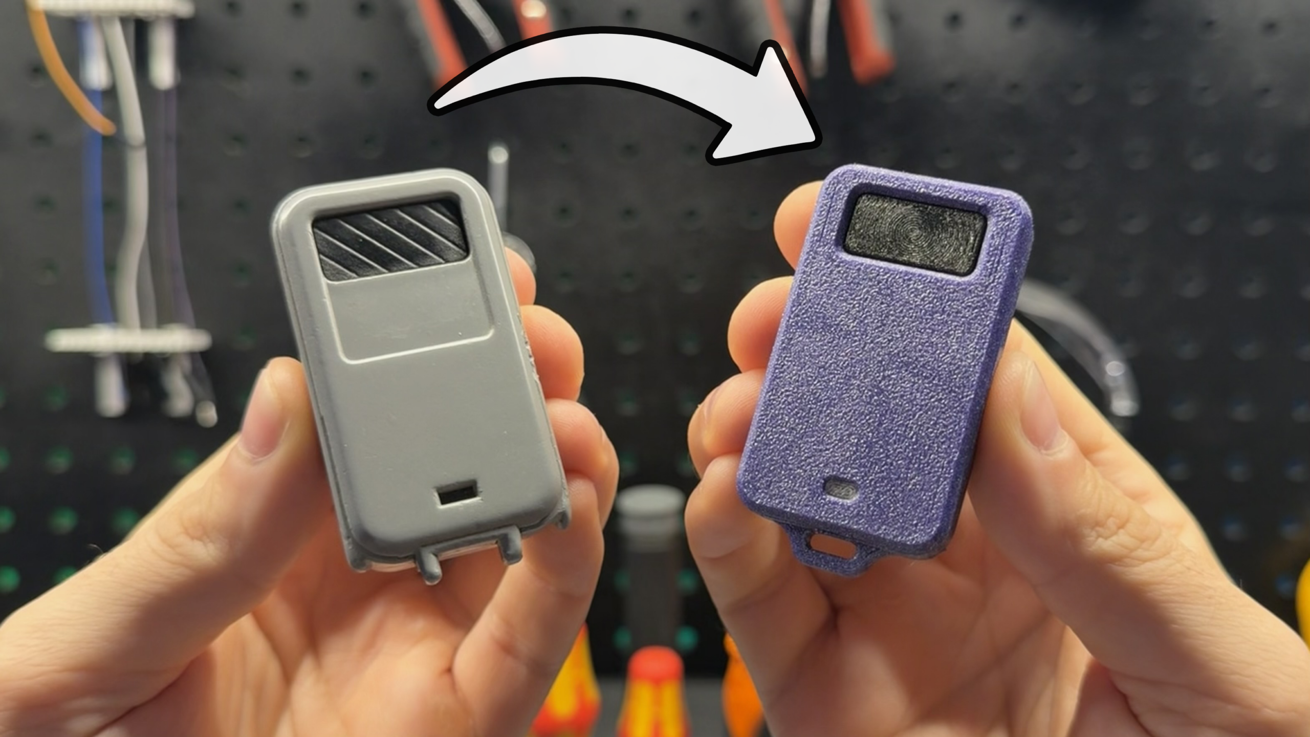 A person holds a grey stock keyfob in one hand and a textured 3D printed purple version in the other hand.